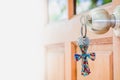 The cross key chain on door knob with sunlight, Christian belief concept Royalty Free Stock Photo