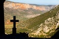 Cross monument silhouette mountain above Leonidio town Greece