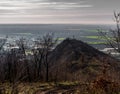 Cross on the mountain, in the background you can see the valley with the city and fields Royalty Free Stock Photo