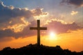 Cross on mountain sunset background. Easter concept.