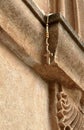 Cross neckless on old rusty wall