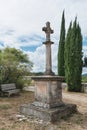 Cross next to the Romanesque church of Saint Pierre in Larnas