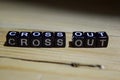 Cross out written on wooden blocks. Inspiration and motivation concepts. Royalty Free Stock Photo