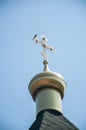 A cross outdoors with a bird