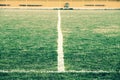 Cross of painted white lines on natural football grass. Artificial green turf texture. Royalty Free Stock Photo