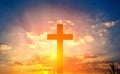 Cross in the rays of the sun against a blue cloudy sky Royalty Free Stock Photo