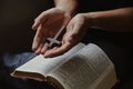 The cross rested on hand of young man while reading and studying bible Royalty Free Stock Photo