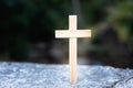 The cross rests on the cement floor. Natural background It is a request for blessing from God, the power of holiness. It