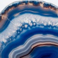Cross-section of an agate geode displaying vibrant blue, white, and orange bands. The Royalty Free Stock Photo
