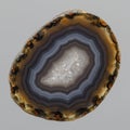 Cross-section of a banded agate, displaying concentric layers of varying colors, Royalty Free Stock Photo