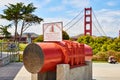 Cross section of Golden Gate Bridge cable on bright summer day with person sitting nearby