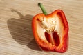 Cross section of sliced fresh red bell pepper on wooden cutting Royalty Free Stock Photo