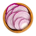 Cross sections of red onions in a wooden bowl Royalty Free Stock Photo