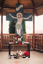 Cross set atop a church altar surrounded by small ornamental decorations in an orthodox church