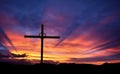 Cross silhouette on the mountain at sunset