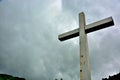 Cross situated on a hill in dramatic clouds