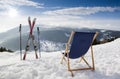 Cross ski and Empty sun-lounger at mountains in winter Royalty Free Stock Photo