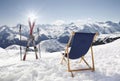 Cross ski and Empty sun-lounger at mountains in winter