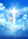 Pigeon over a cross in the cloudy sky background with light rays Royalty Free Stock Photo