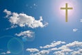 Cross in the sky with sun flare behind it Royalty Free Stock Photo