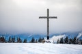 Cross in the snow. Wooden religious cross in winter. Les Pleiades, Switzerland