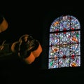 Cross and stained-glass window in church in Nice Royalty Free Stock Photo