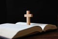 Cross standing on book isolate on black background Royalty Free Stock Photo