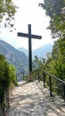 Cross is standing in the middle of a path in the woods Royalty Free Stock Photo