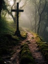 Cross stands alone in middle of pathway, surrounded by trees and foliage. The scene is enhanced with fog or mist Royalty Free Stock Photo