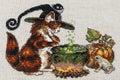 Cross-stitch embroidery with cat in hat, cauldron, toad, bonfire and pumpkin