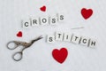 Cross stitch, needle and vintage scissors Royalty Free Stock Photo