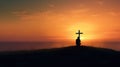 Cross in sunset and lone silhouetted person praying