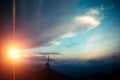 Cross at sunset in wild mountains with three people Royalty Free Stock Photo