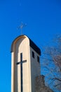 Cross on top of tower church against deep blue sky and morning crescent
