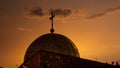 The Cross at the top of the Church of Sepulchre in Jerusalem, Israel at the sunset.