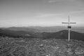 Cross on the top of mountains black and white. Faith and memory sign.Christian religion symbol monochrome. Road to nowhere. Royalty Free Stock Photo