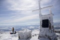 Cross on top of a snowy mountain