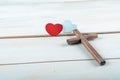 Cross and Two wooden red and white hearts. GOD IS LOVE concept