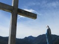 Cross and Virgin Mary in front of mountains Royalty Free Stock Photo