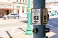 Cross walk sign and button for pedestrians to cross a downtown intersection Royalty Free Stock Photo