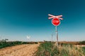 Crossbuck and stop sign on countryside road and railway intersection