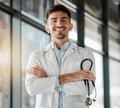 Crossed arms, happy and portrait of a male doctor with a stethoscope in a medical hospital. Confidence, smile and Royalty Free Stock Photo