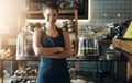 Crossed arms, waitress and portrait of woman in coffee shop for service, welcome and barista job. Professional, small Royalty Free Stock Photo