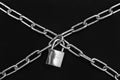 Crossed chains with padlock on black background. Security concept