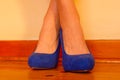 Crossed feet in blue heels