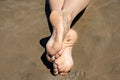 Crossed feet in sand Royalty Free Stock Photo
