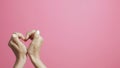 Crossed fingers of a girl on a pink studio background, hands showing a hashtag shape, concept social networks, indexing, a screens