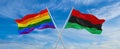 crossed flags of lgbt and Pan-African flag waving in the wind at cloudy sky. Freedom and love concept. Pride month. activism,