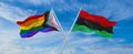 crossed flags of progress lgbt pride and Pan-African flag waving in the wind at cloudy sky. Freedom and love concept. Pride month