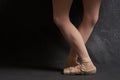 crossed legs ballerinas ballet shoes performance dark background